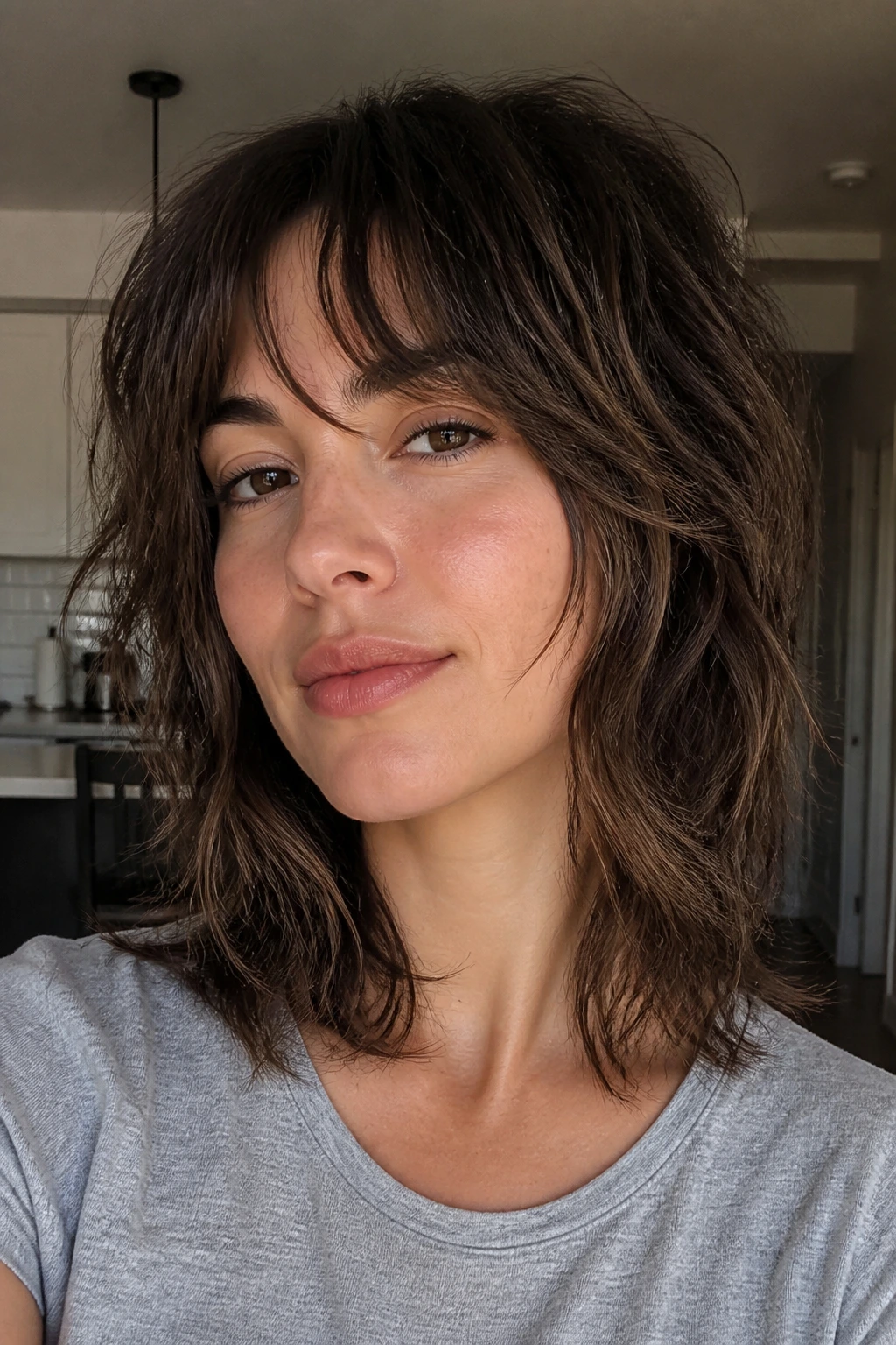 Close-up portrait of a real person with air-dry layered shag and bottleneck bangs