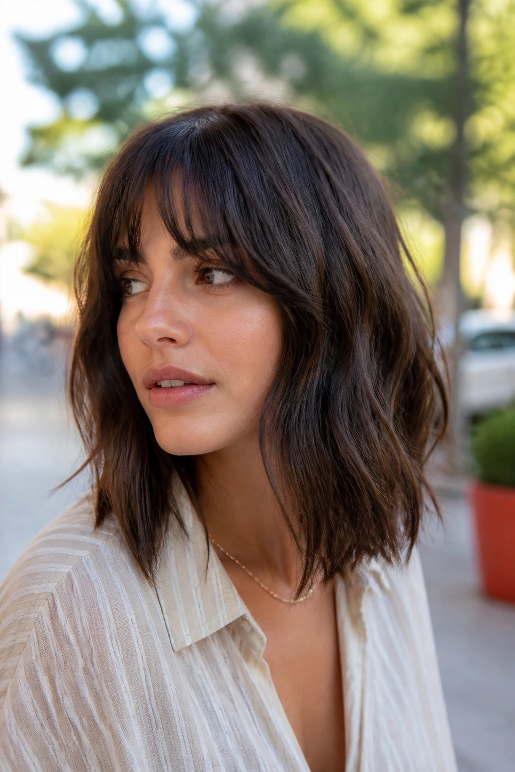Close-up of a real woman with an airy shag lob in natural light
