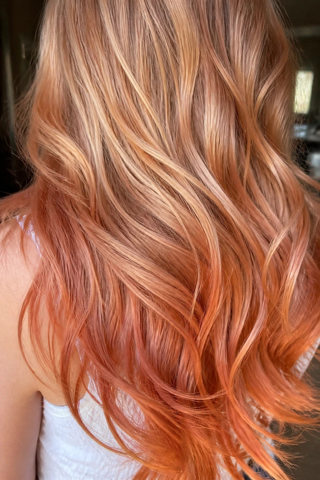 Close-up of long hair with apricot copper ends and beige-gold mids