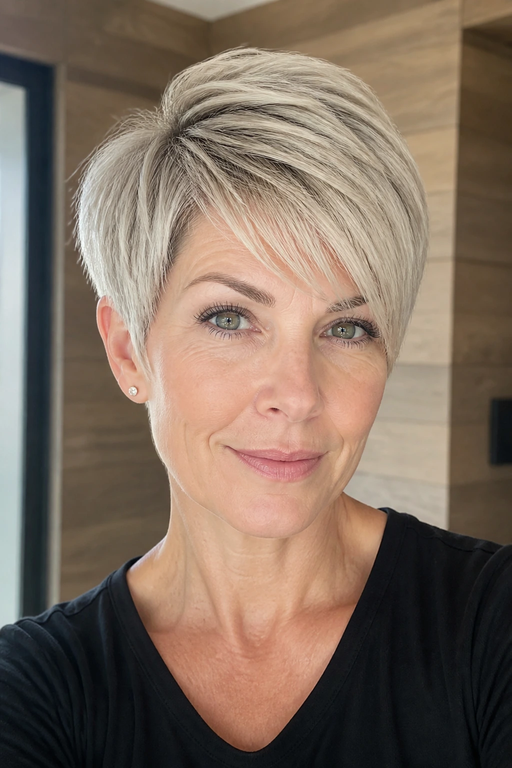 Close-up of real woman with ash blonde long pixie, top longer, daylight.