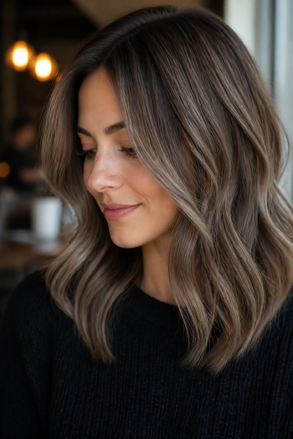 Portrait of a real woman with ashy mocha ribbons for low-contrast dimension in medium-length hair