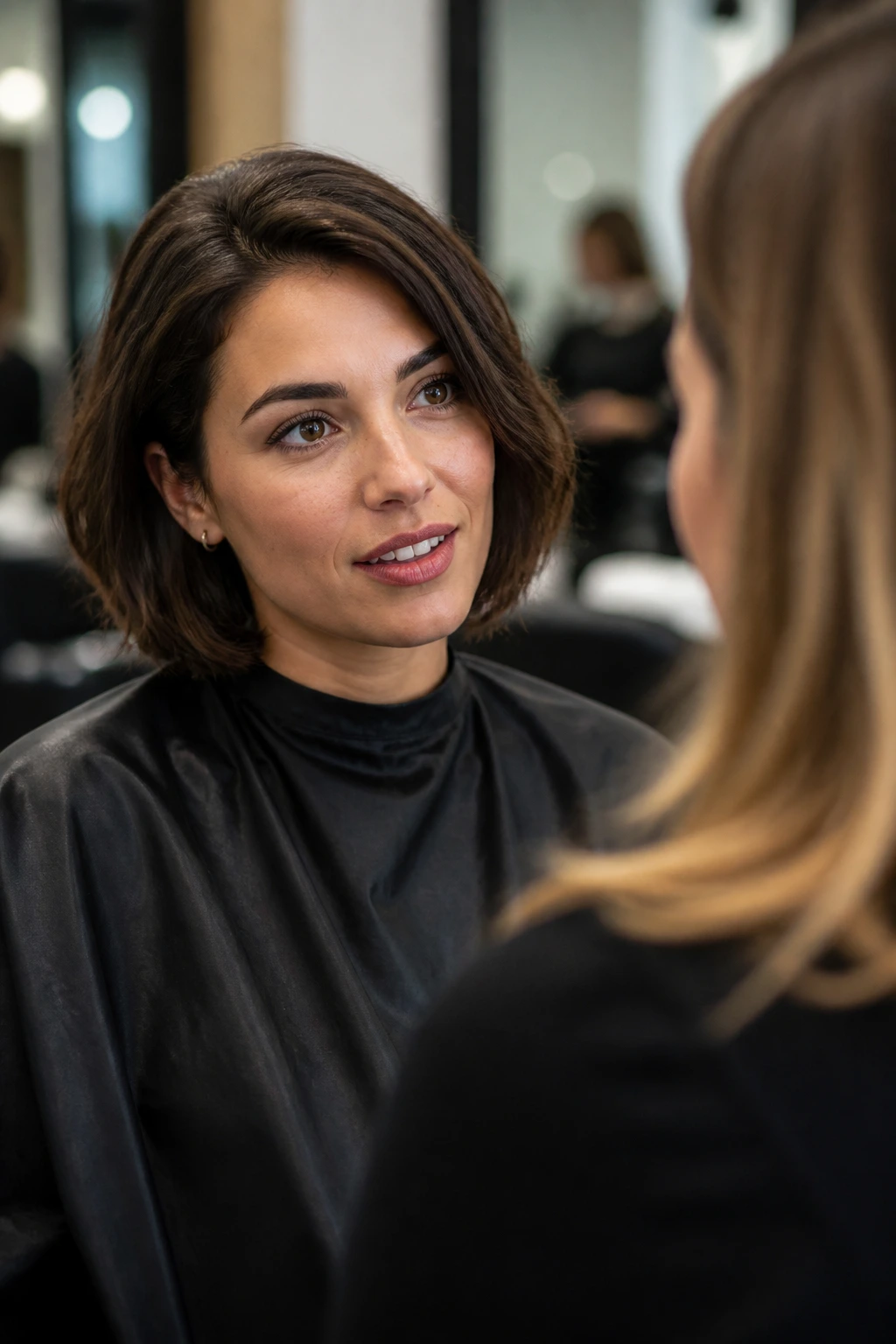 Real woman in salon chair preparing to discuss haircut
