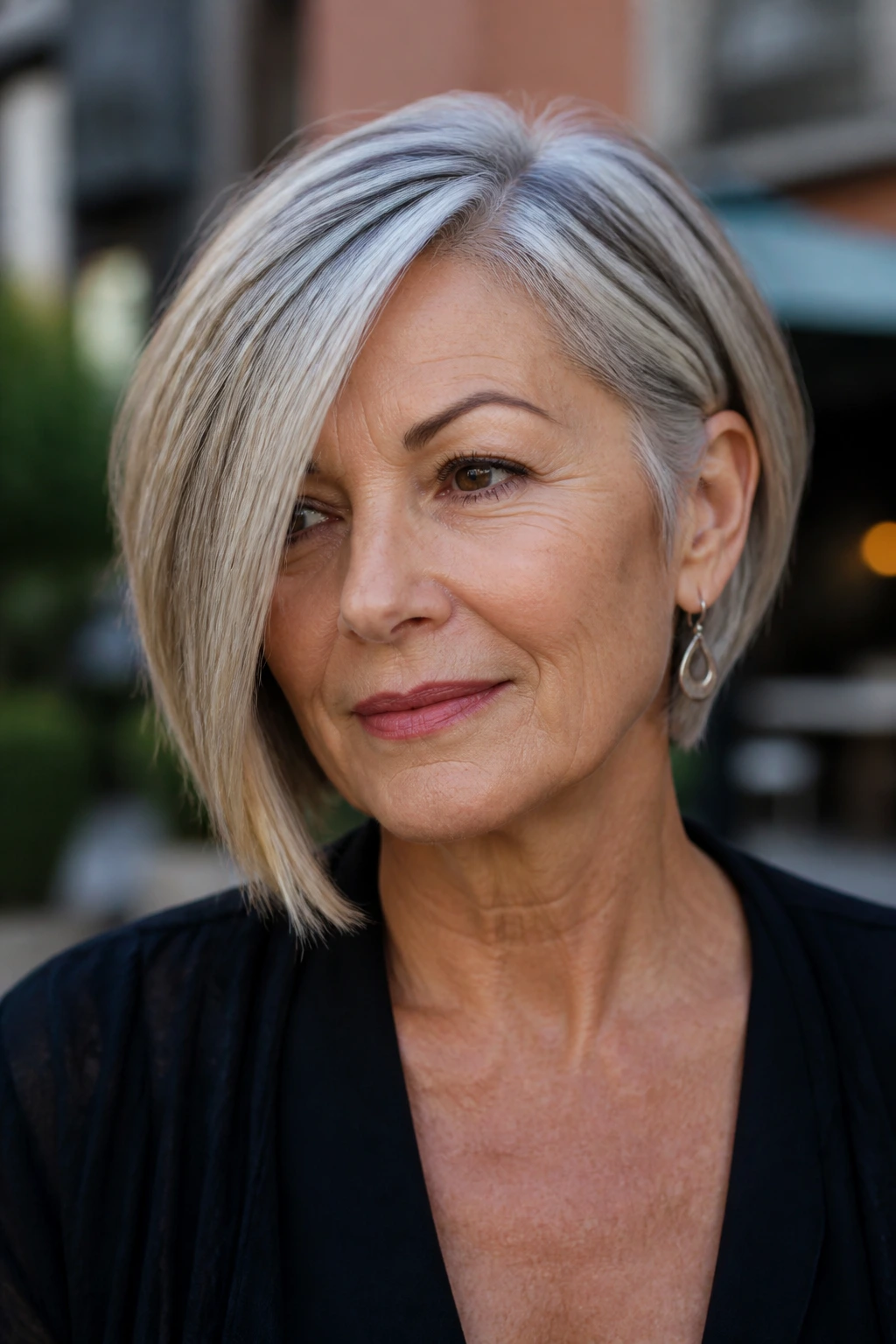 Close-up of a real woman with an asymmetrical bob and a deep side part.