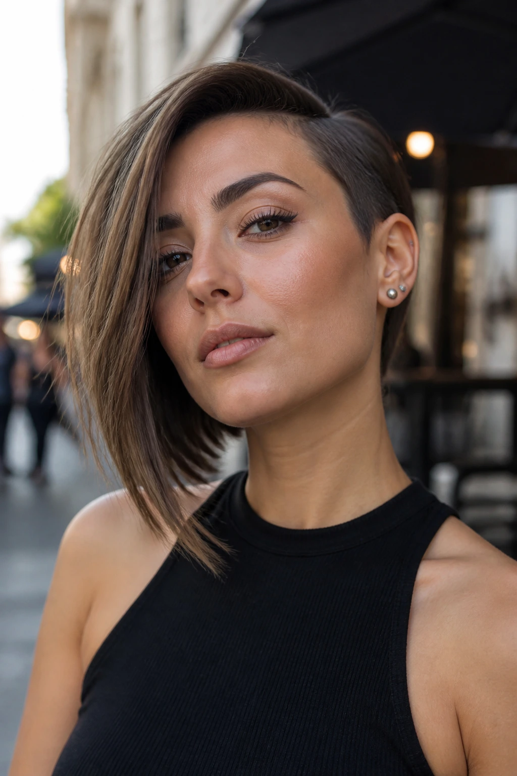 Real woman with an asymmetrical bob featuring one longer side and balanced sharp lines.