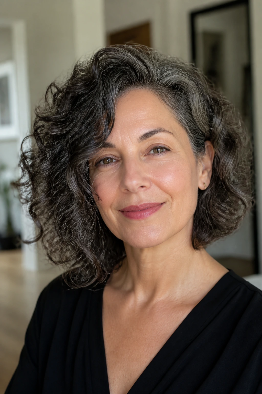 Real woman with asymmetrical curly lob, longer side balancing the jawline.