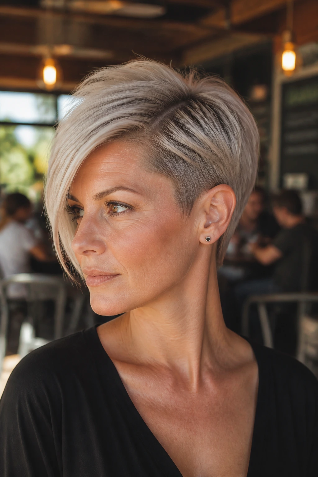 Close-up portrait of a real woman with asymmetrical pixie, longer side and shorter opposite temple