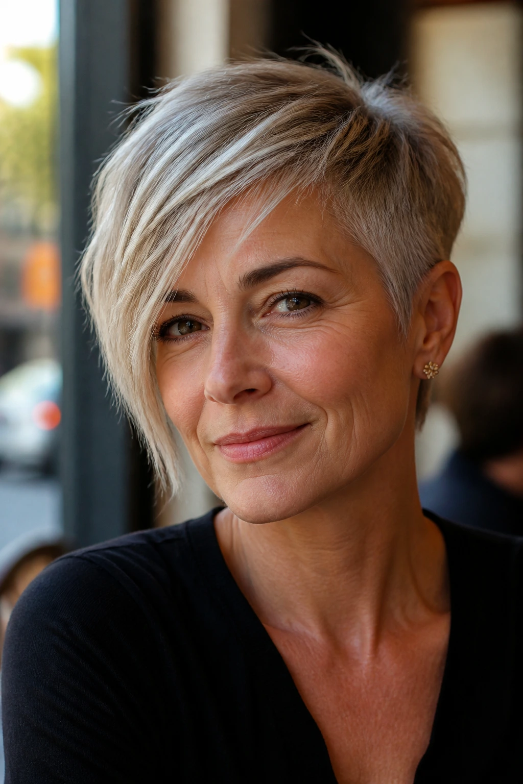 Close-up portrait of a real woman with an asymmetrical pixie hairstyle featuring one longer side and sharper silhouette