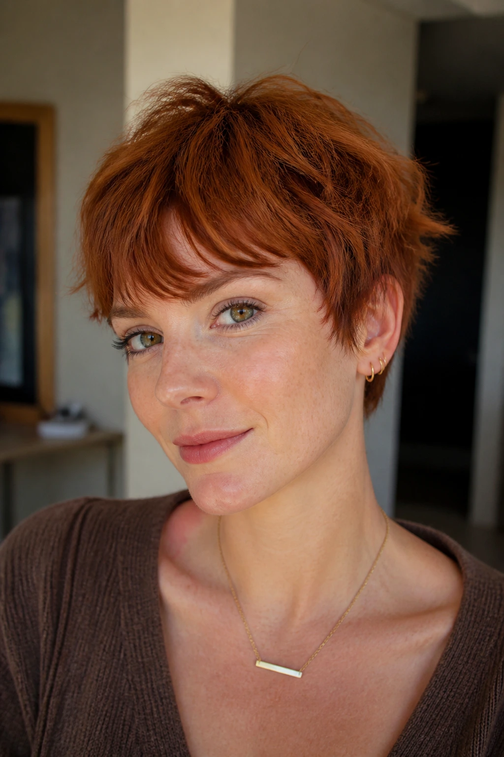 Close-up portrait of a real person with messy auburn crop and micro-layers