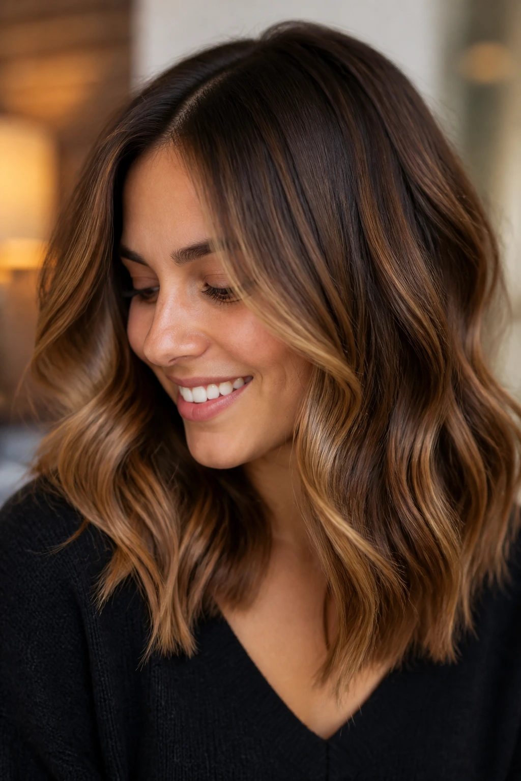 Close-up portrait of chestnut base with toffee balayage highlights