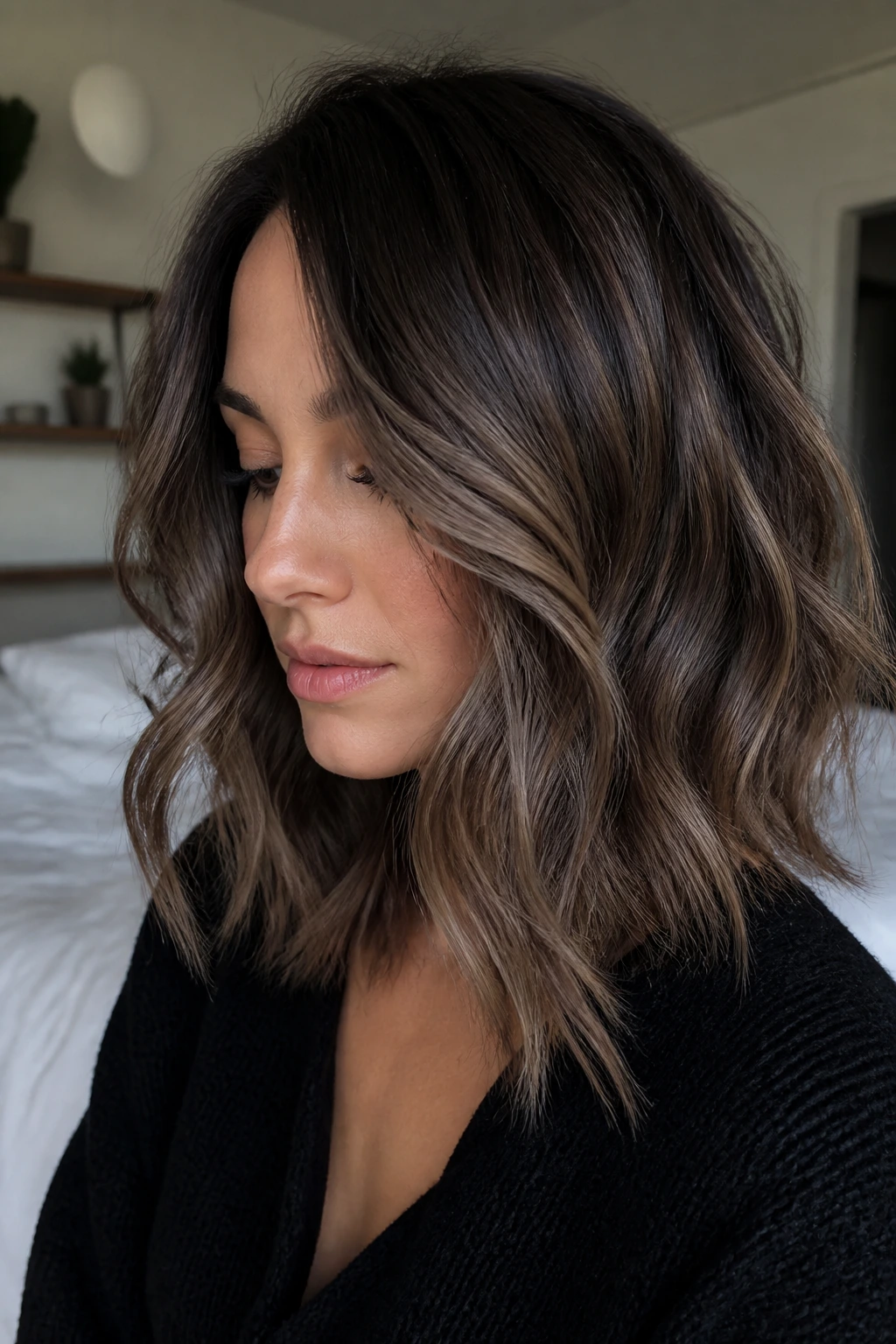 Wavy mushroom brown balayage with smoky taupe tones for a velvet look.