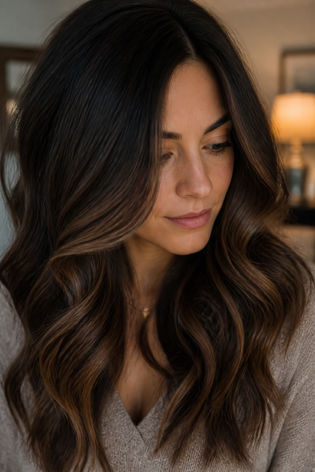 Close-up of sable balayage on dark brunette hair showing subtle dimension.