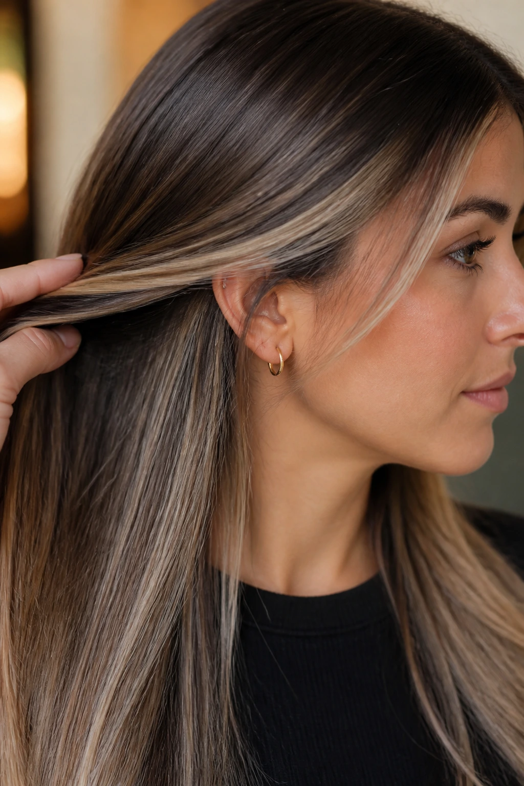 Portrait of a person with straight balayage displaying a soft blend and shiny finish.