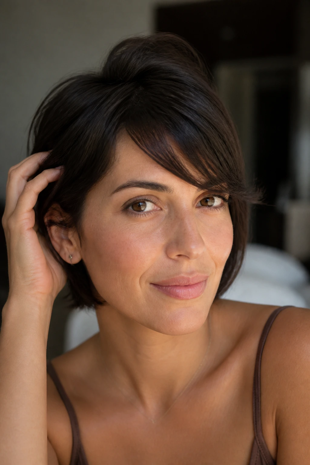 Portrait of a person with swoopy bangs maintained between trims using light lift at the roots