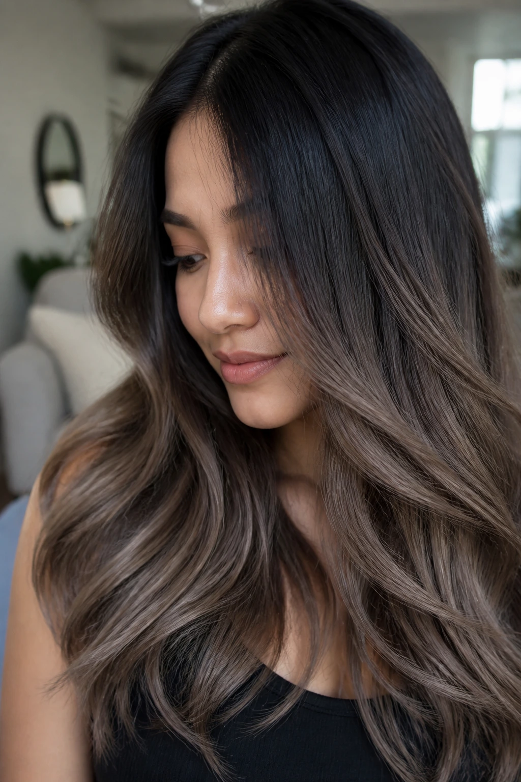 Real woman with black to cool ash brown ombre in a cozy setting