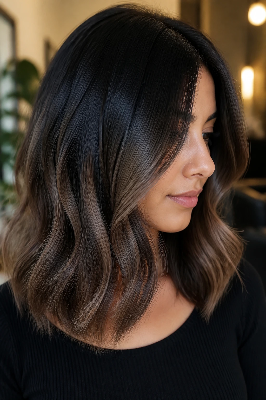 Close-up portrait of a real woman with black-to-mocha ombre on medium-length hair