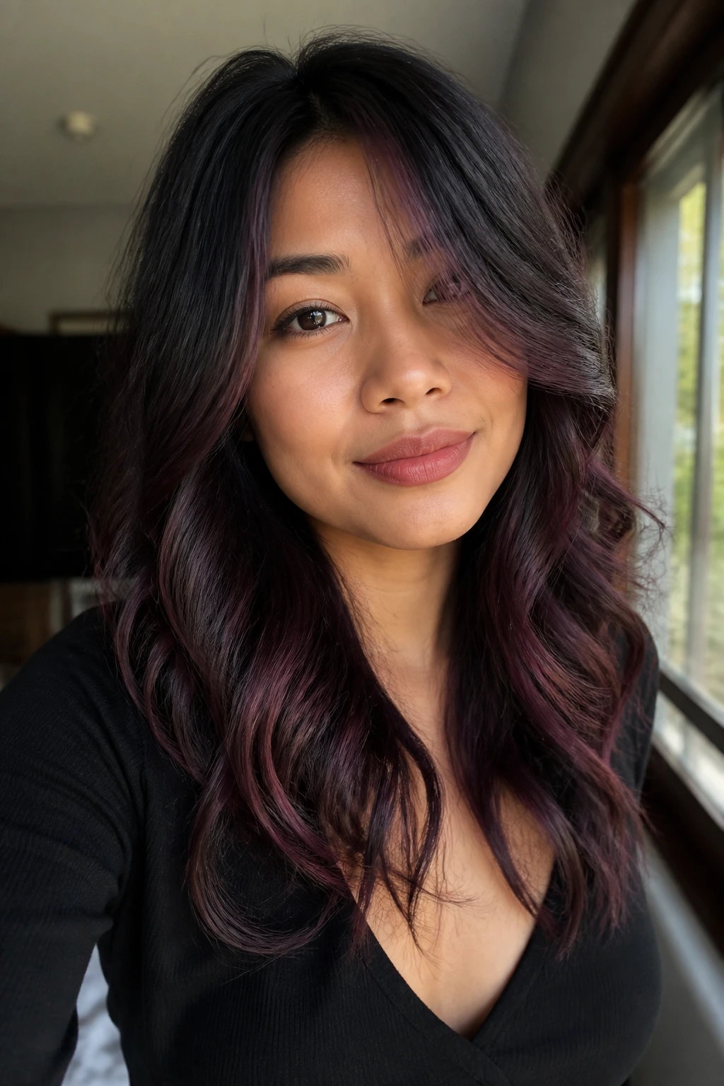 Close-up of black hair with dusty rose-violet tint in waves