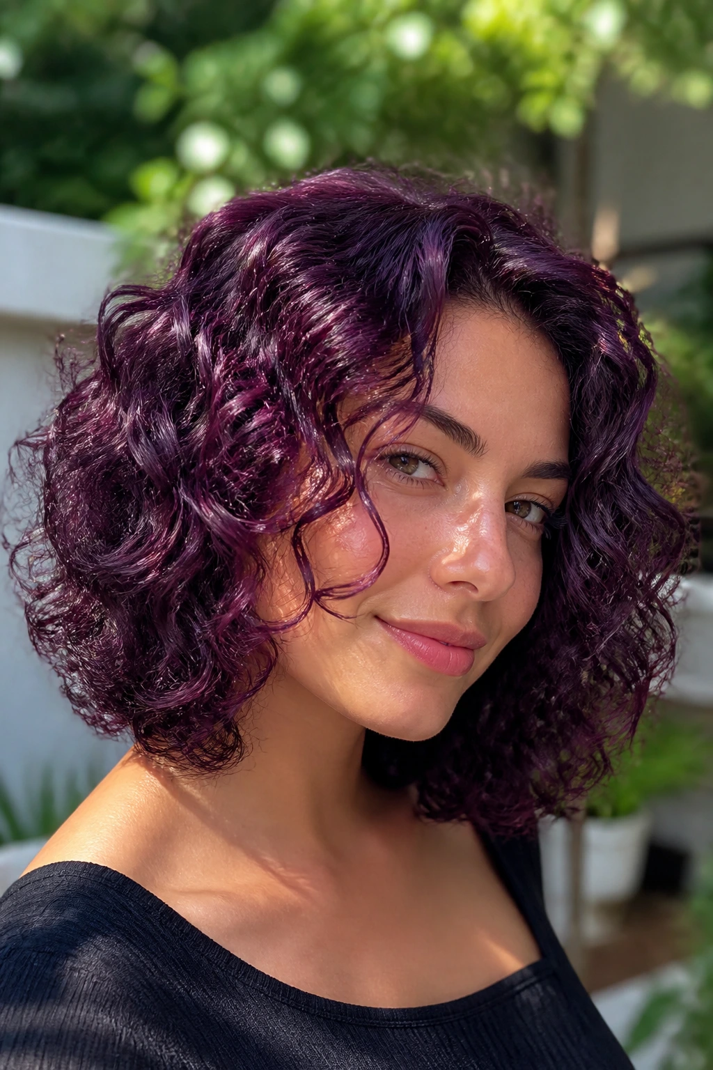 Real woman with blackberry curly lob, rich purple curls and shine