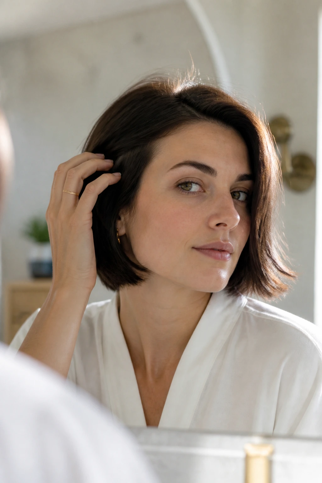 Close-up of a real woman with an effortless bob in morning light