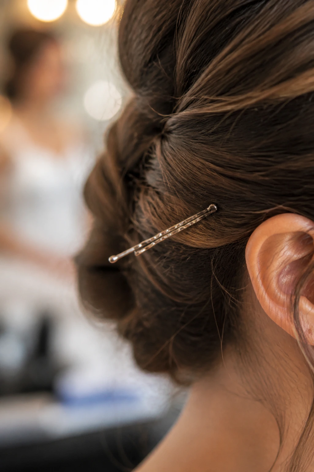 Ridged bobby pin gripping hair in bridal prep