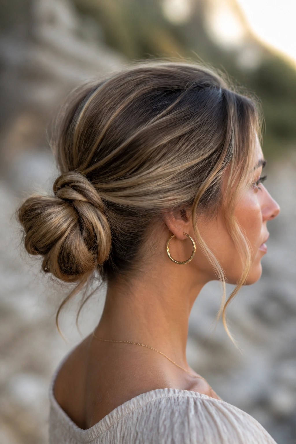 Real person with a boho-wrapped ponytail into a bun