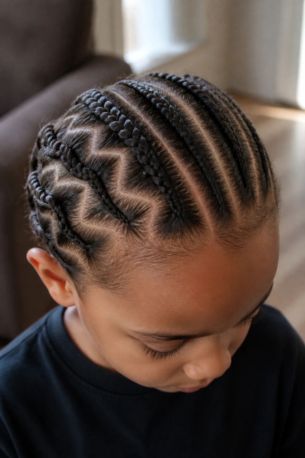 Head with multiple braids showing different part styles across the scalp.
