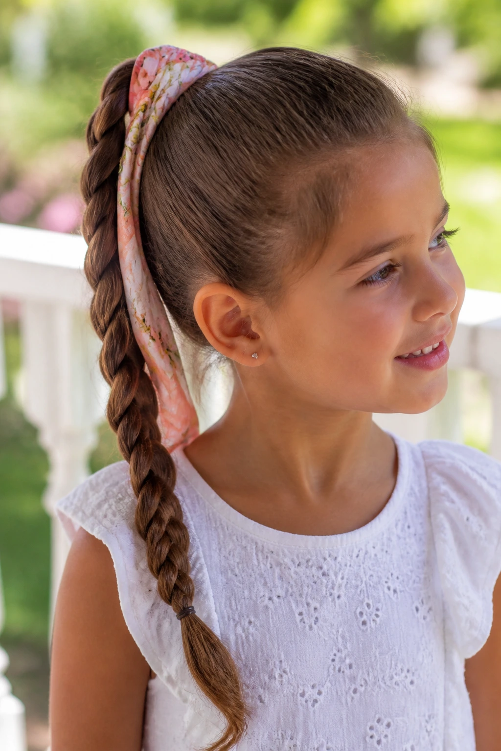 Close-up of brunette hair in a braided ponytail with a wrap