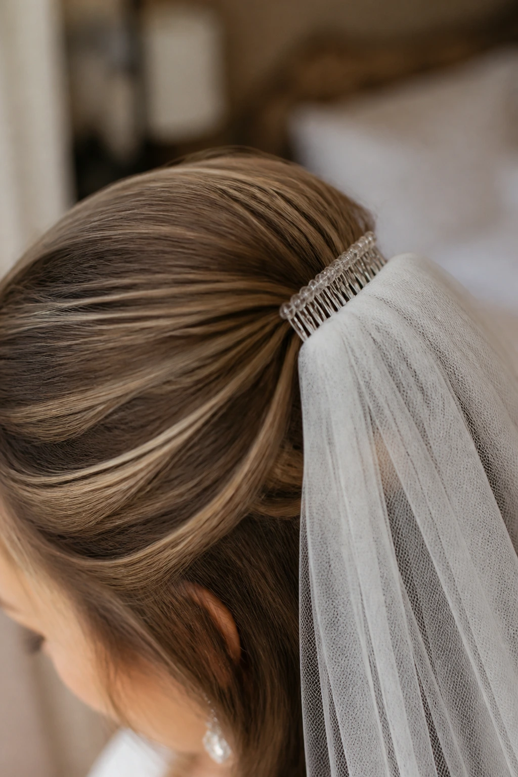 Close-up crown showing extension-supported volume under veil