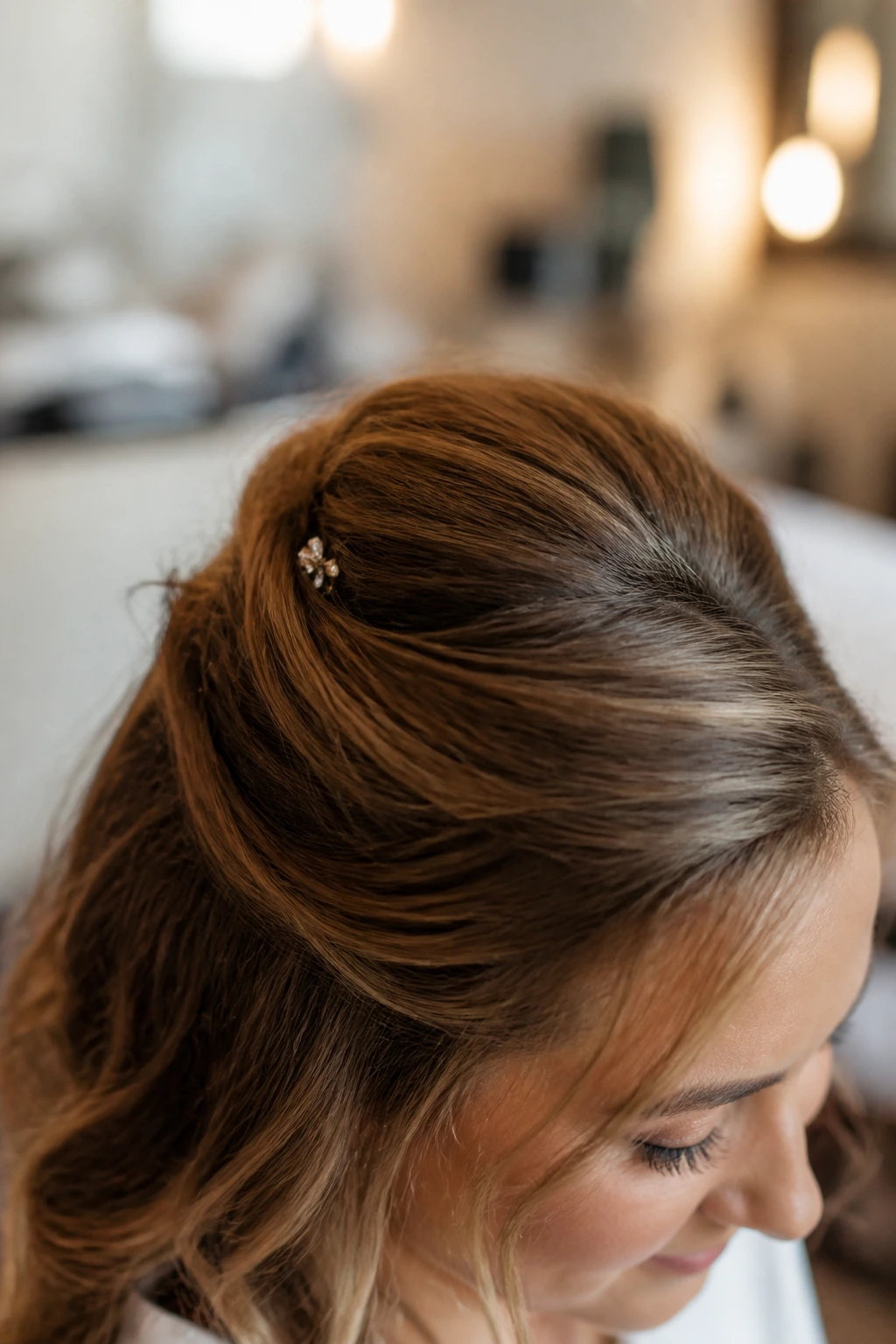 Bride's crown area with tiny finishing pin under the top hair section