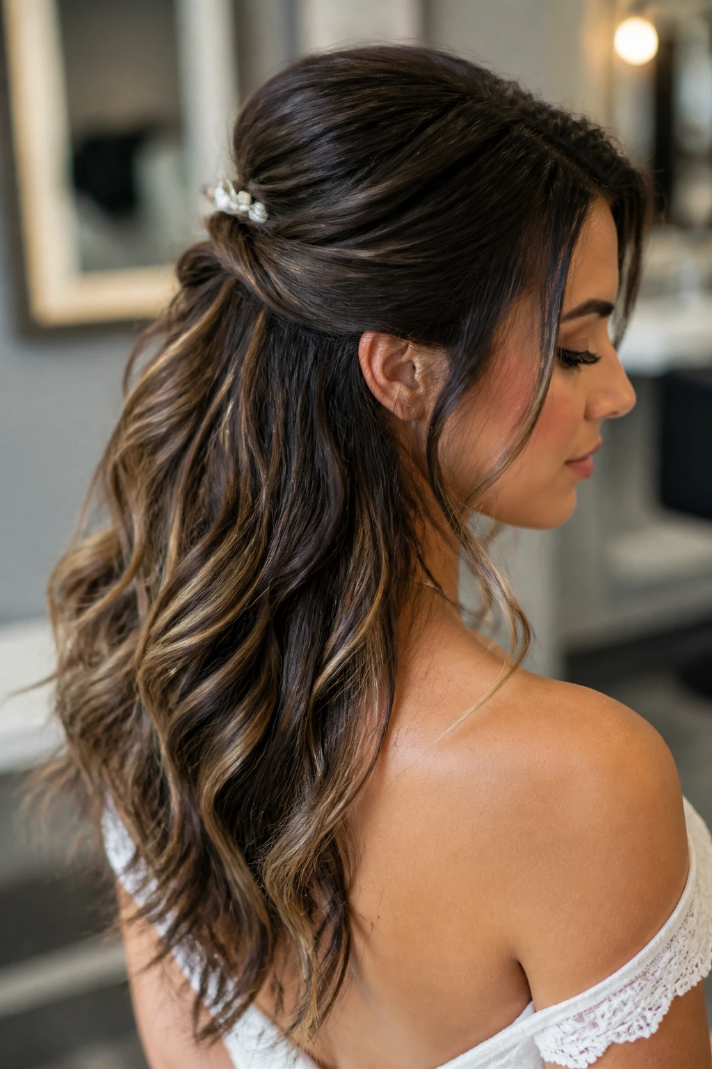 Bride showing a soft half-up bridal style highlighting texture and smoothness