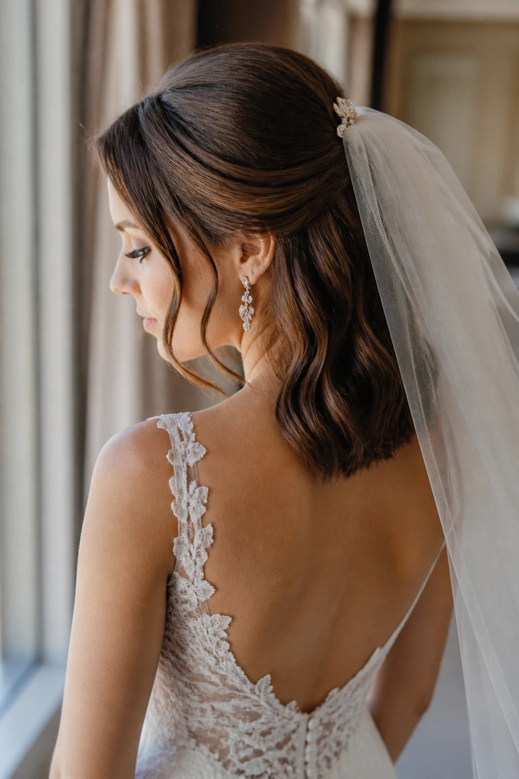 Bride with veil clipped hairstyle and visible earrings