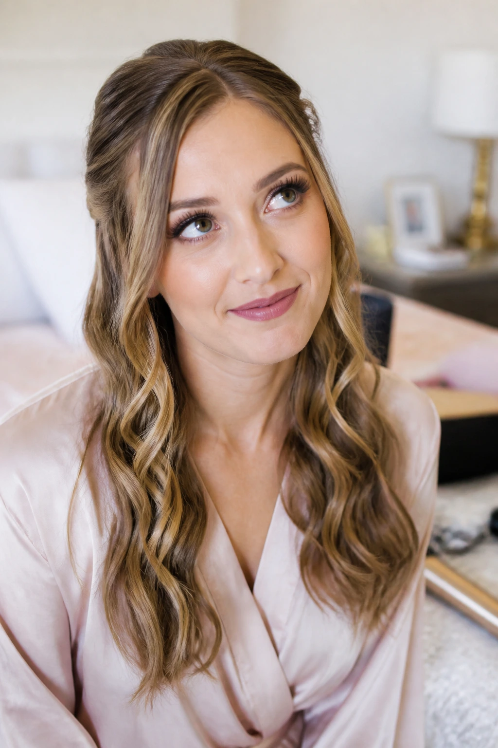 Portrait of bridesmaid pondering half-up style in a cozy room