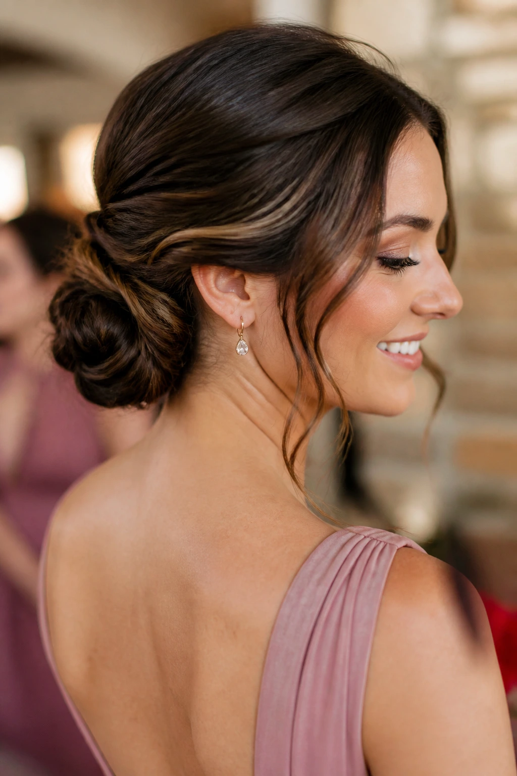 Close-up of a real bridesmaid with a durable updo in a wedding prep setting
