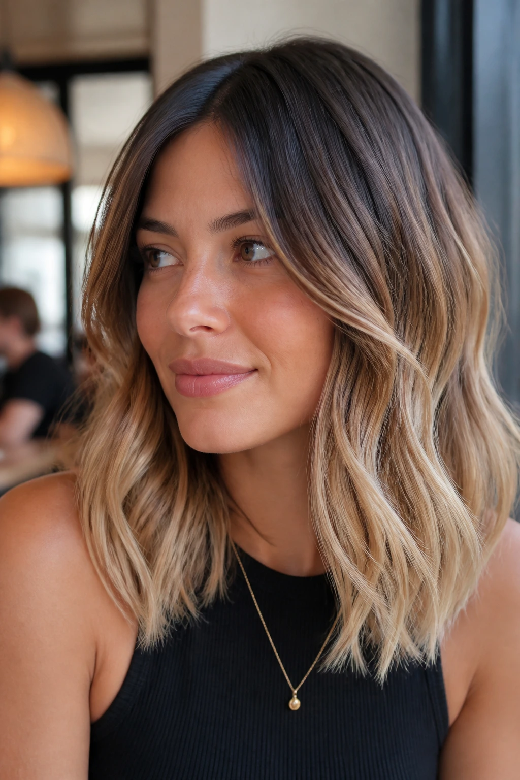 Close-up of a real woman with bronde hair, dark roots and blonde ends