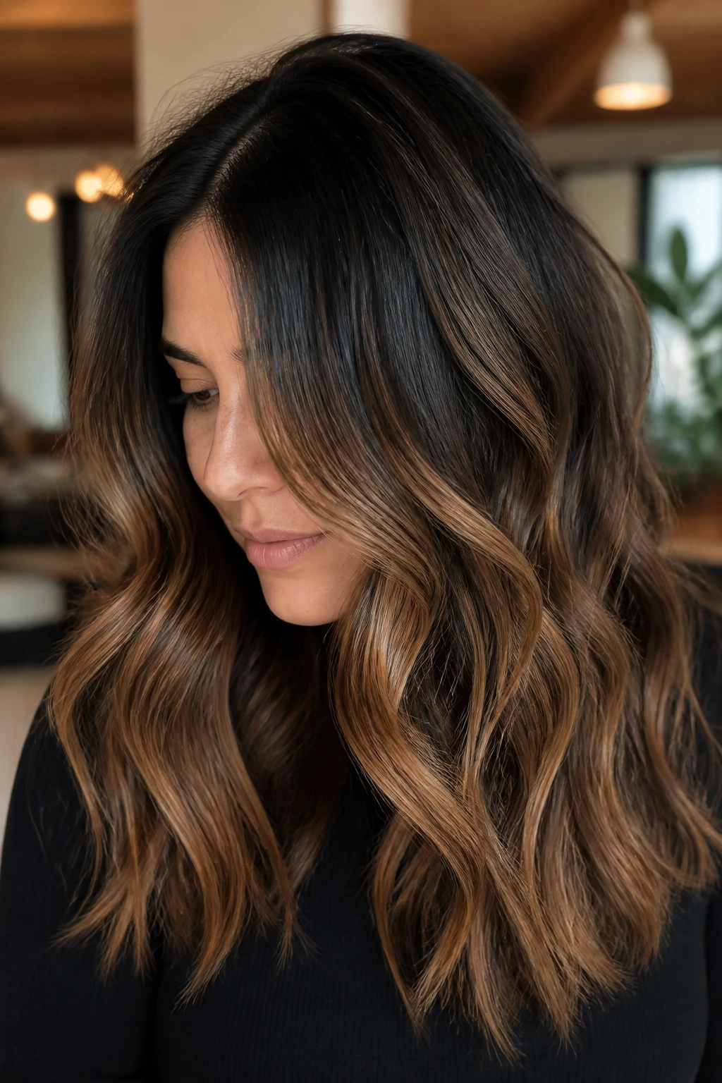 Close-up of brunette with bronze balayage and soft shadow root.