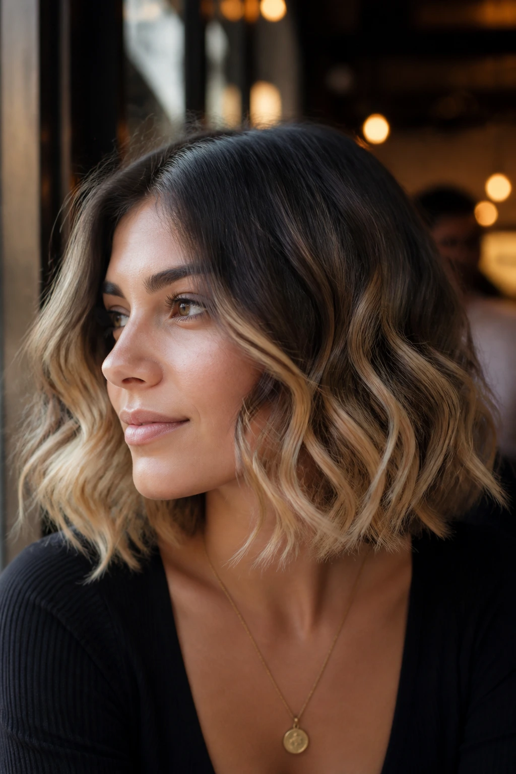 Real woman with brunette to honey blonde ombre in warm window light