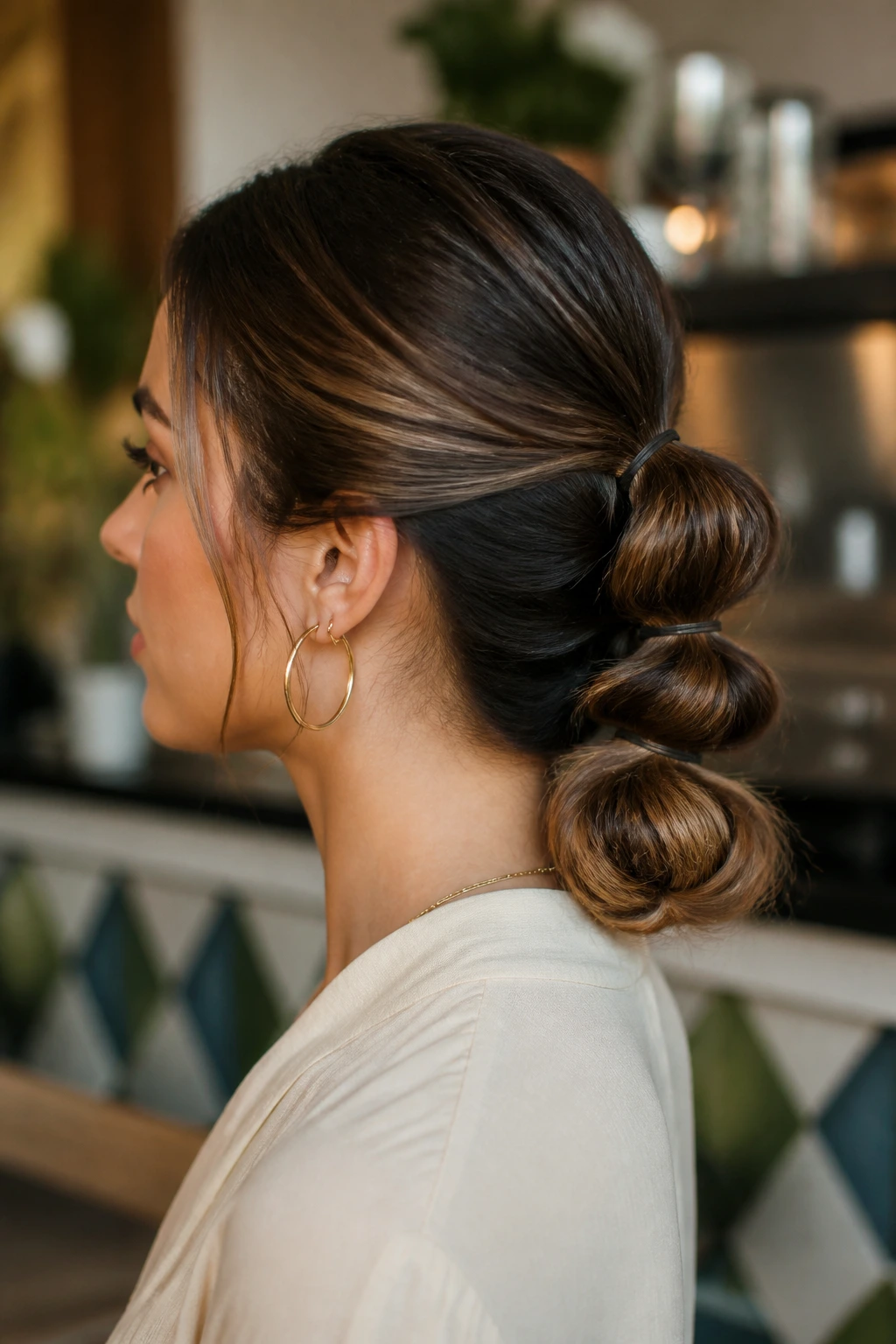 Close-up portrait of a real woman with a bubble-detail low bun