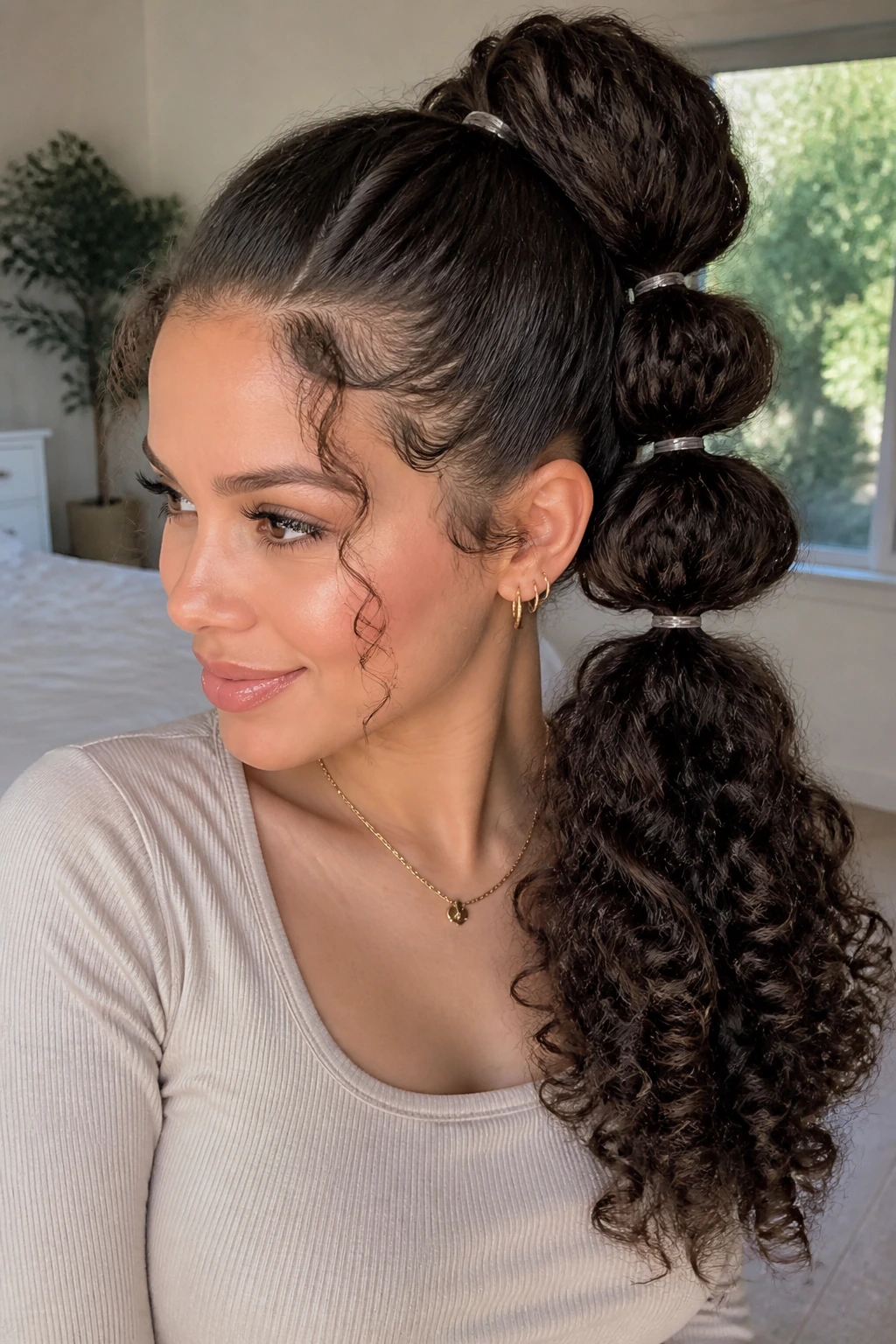 Real woman's head with a bubble ponytail and curls.