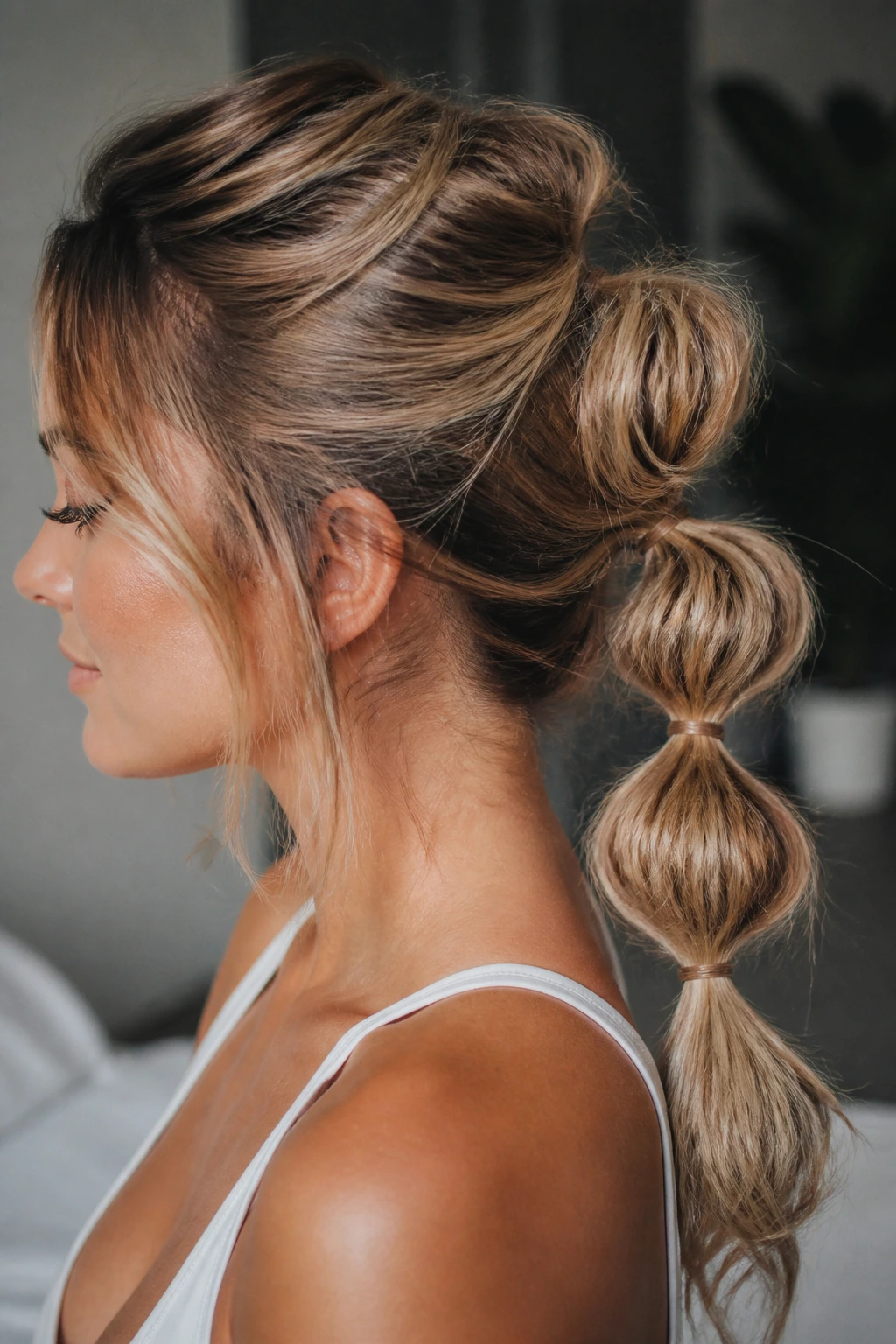 Close-up of real woman with bubble messy ponytail showing elastic bubbles