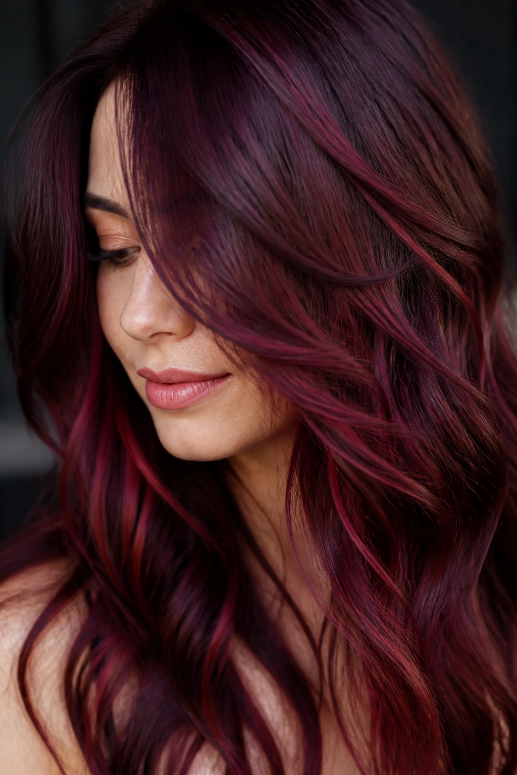 Real person with multi-tonal burgundy hair showing depth