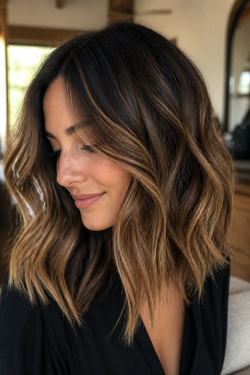 Brunette with caramel ribbon balayage in loose waves
