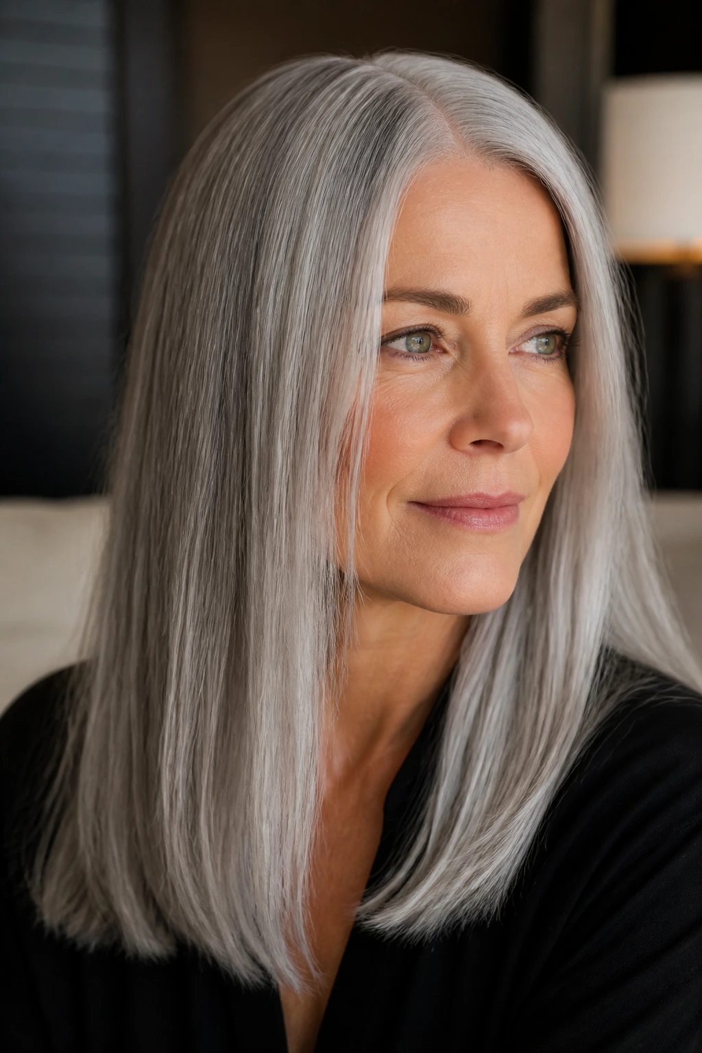 Portrait of a woman with sleek center-parted gray hair