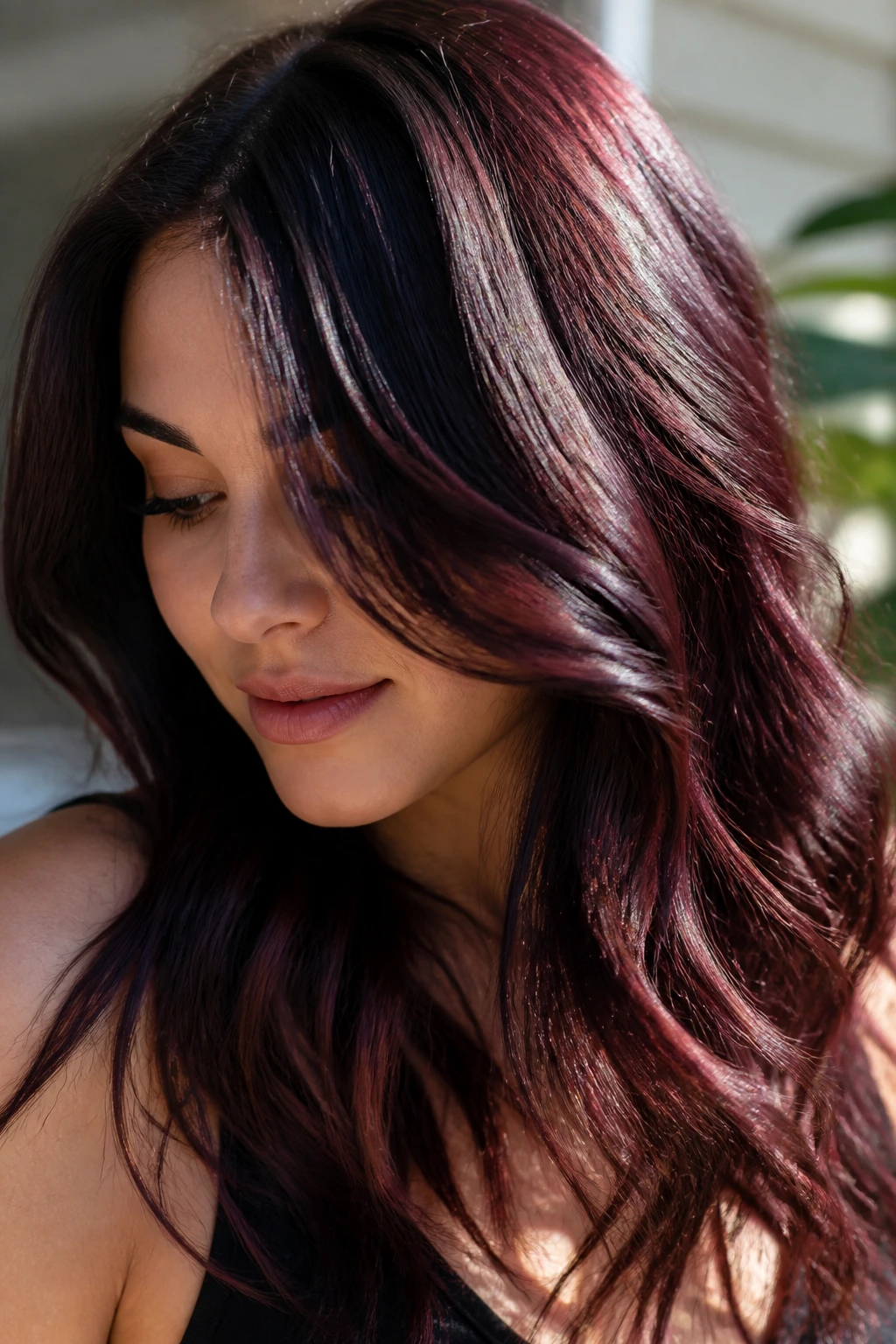 Close-up of cherry cola brunette with red-violet reflections