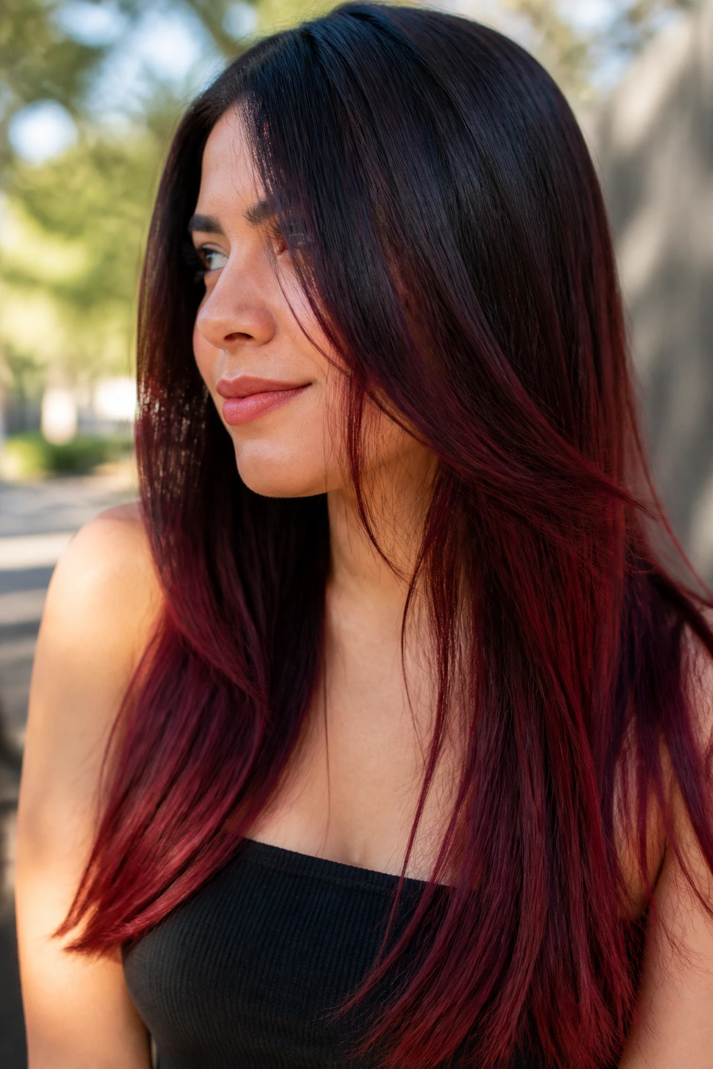 Portrait of a real woman with cherry cola ombre on straight hair