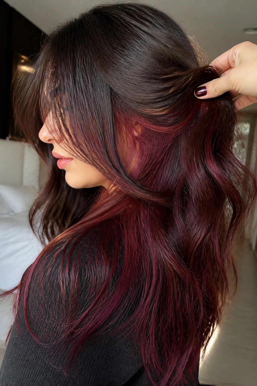 Burgundy-red peekaboo underlayer visible in hair on a real person