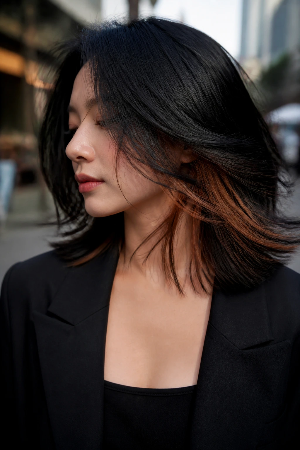 Close-up of black hair with chestnut underlayer peeking through