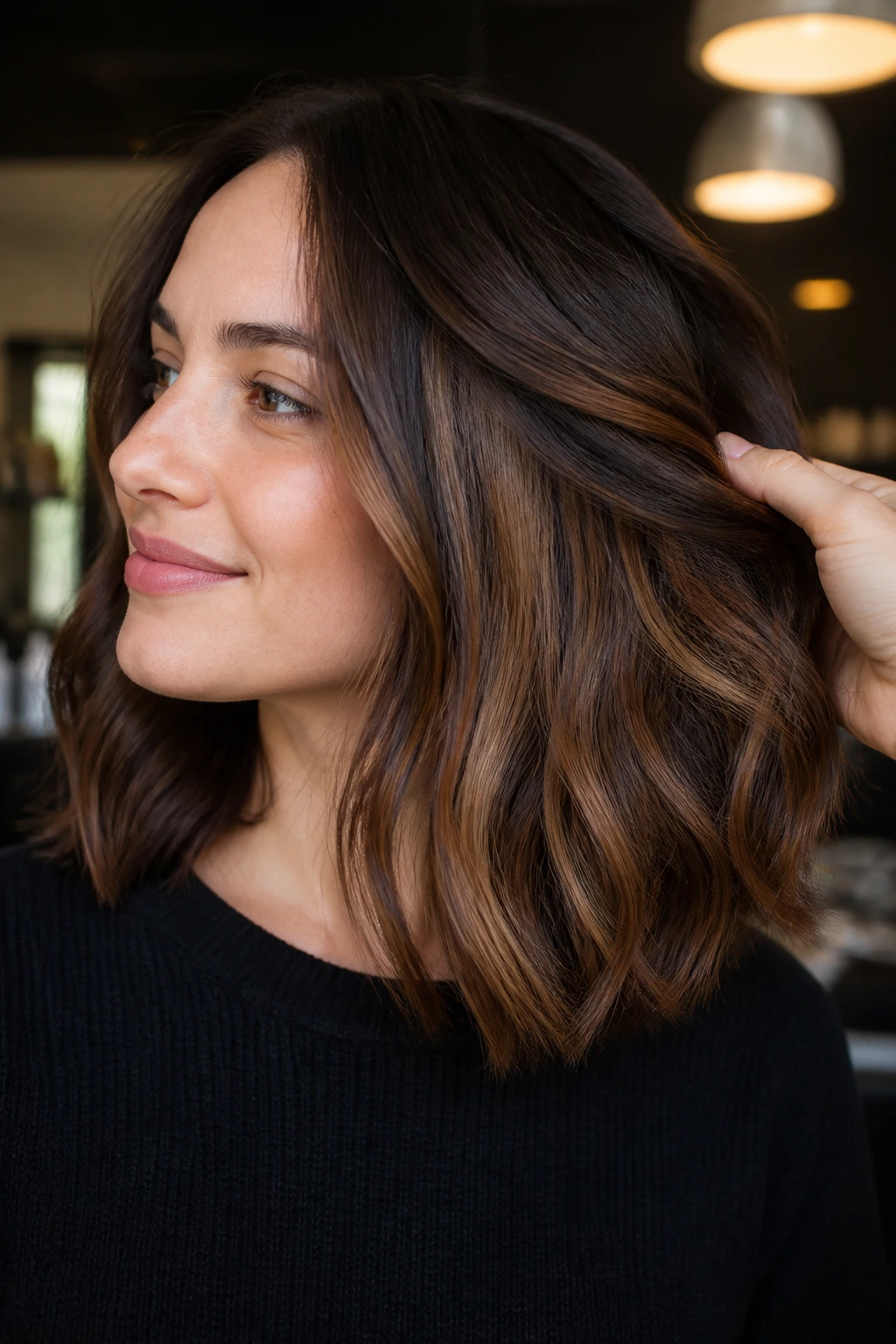 Shoulder-length brunette with chestnut underlights visible beneath the top layer.