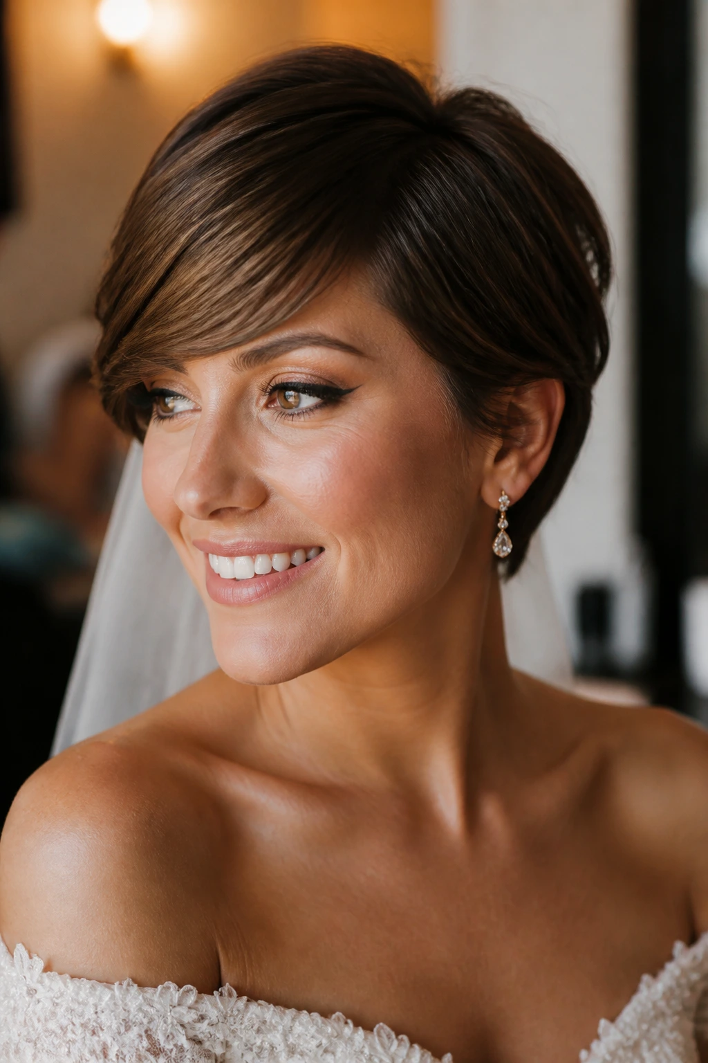 Bride with chin-length crop and side-swept fringe in warm bridal prep light