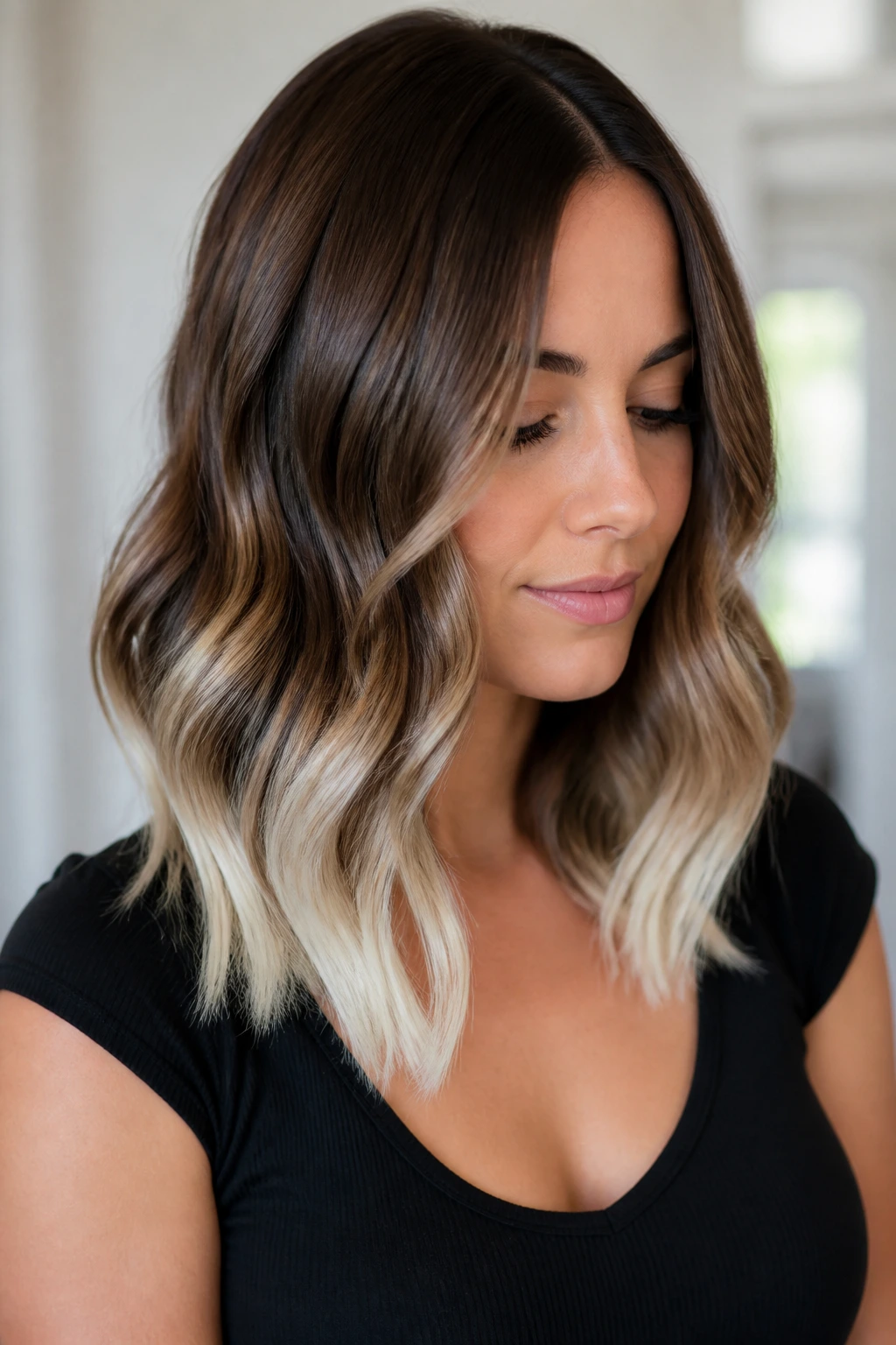 Close-up portrait of a real woman with chocolate to platinum dip on medium-length hair