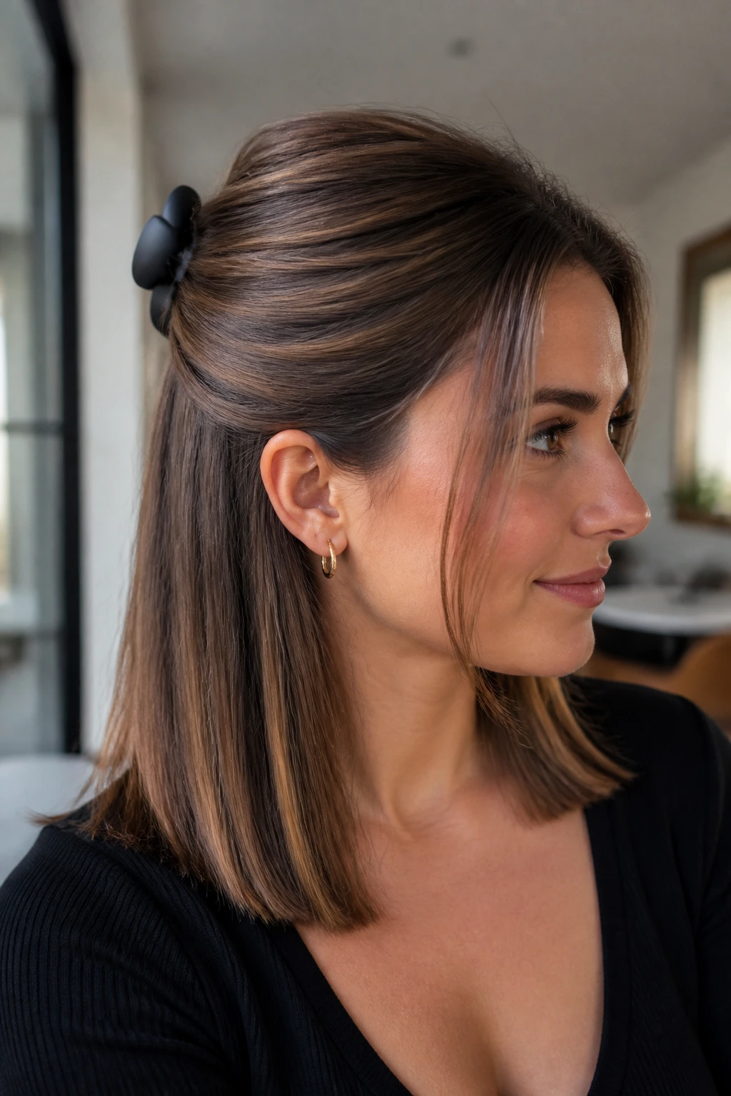 Close-up of a real woman wearing a claw-clip half-up sweep
