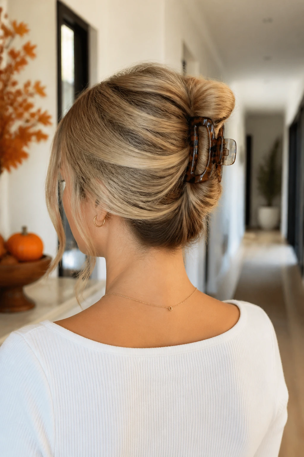 Portrait of a woman with a claw-clip twist in an autumn setting